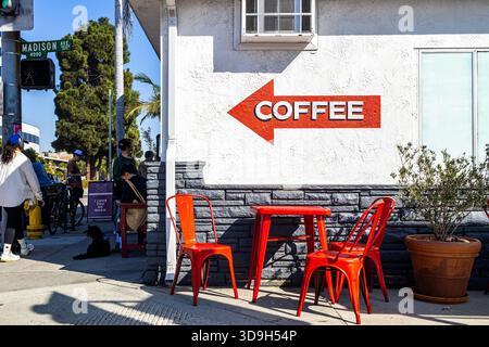 Coffee shop exterior, sidewalk café with red chairs and red arrow reading "COFFEE" in Culver City, California Stock Photo
