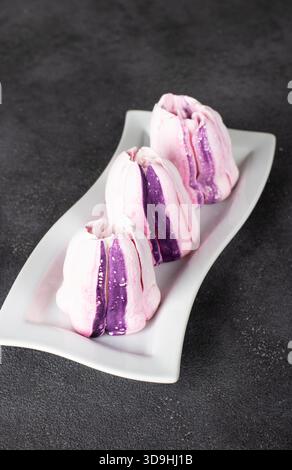 Homemade strawberry marshmallows on white plate on gray background Stock Photo