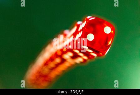 red dice  on a green background, close up Stock Photo