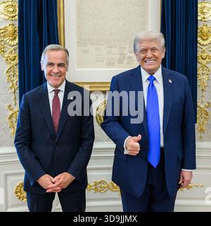 President Donald Trump poses for photos with Canadian Prime Minister Mark Carney before their meeting in the Oval Office, Tuesday, October 7, 2025. Stock Photo