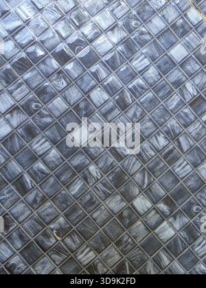 Modern abstract grey mosaic tile pattern background. geometric square tiles have glossy, marbled texture creating sophisticated and sleek surface for Stock Photo