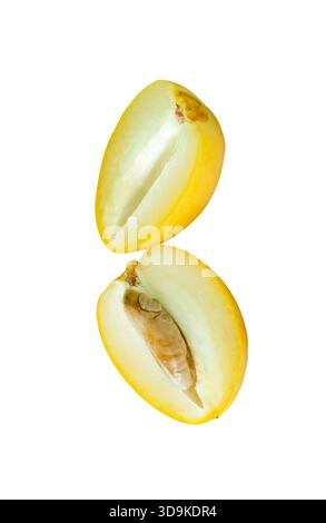 Fresh ripe yellow date palm fruits in two halves in stack are isolated on white background with clipping path. Concept of iftar food in Ramadan for Mu Stock Photo