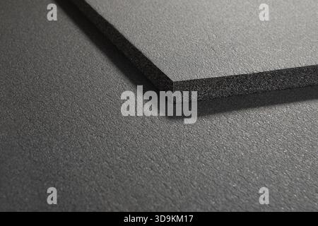 Sponge-like polymer sheets stacked on top of each other. Close-up view of black polymer sheets. Stock Photo
