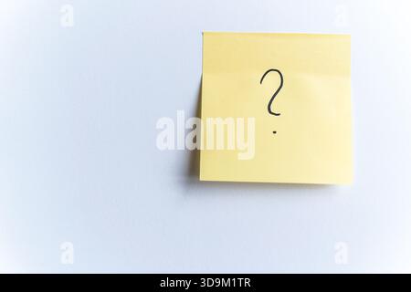 Yellow sticky note with question mark Stock Photo