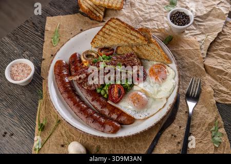 Full English breakfast meal on rustic wooden table Stock Photo