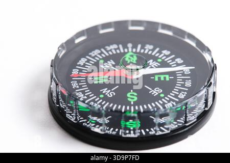 Compass is highlighted on white background in close up. Focus on tip arrow Stock Photo
