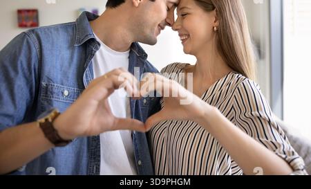 Loving couple making heart shape with hands Stock Photo