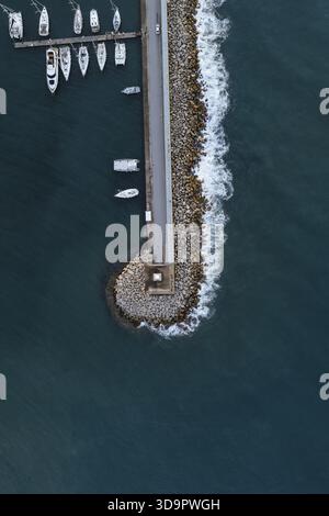 Aerial view of boats moored alongside an airport, reflecting a serene ...