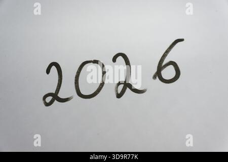 Handwritten 2026 on a bright background, ideal for New Year celebrations, Silvester countdown visuals and creative year end greetings for 2026 and 202 Stock Photo