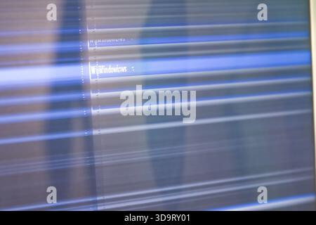 An abstract representation of a computer screen displaying distorted lines and text, creating a dynamic visual effect. Stock Photo