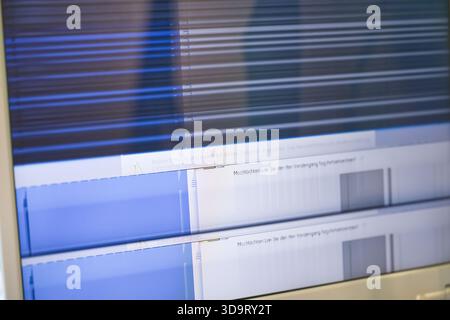 A close-up view of a computer screen displaying distorted lines and graphical data, possibly related to signal processing or audio analysis. Stock Photo