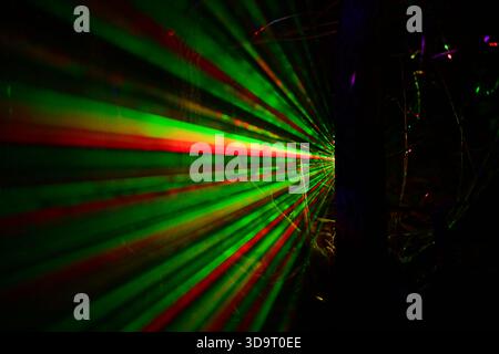Abstract image of green and red laser beams in a dark environment, creating a futuristic and dynamic visual effect. Stock Photo