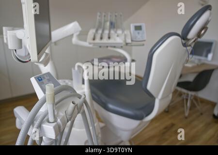 A modern dental chair in a clinic, featuring advanced dental equipment and a clean, organized environment. Stock Photo