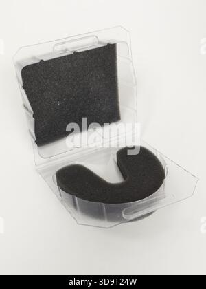 A transparent plastic case with a black foam insert shaped like a 'U'. The case is open, revealing the foam inside, set against a white background. Stock Photo