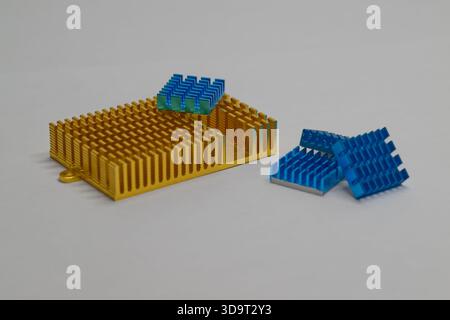 A collection of computer heat sinks in Golden and blue colors, including gold and blue, arranged on a light background. The heat sinks are designed fo Stock Photo