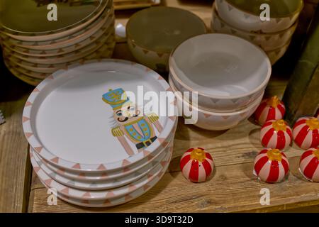 A collection of decorative plates and bowls featuring a nutcracker design, arranged on a wooden surface. The plates have a geometric pattern around th Stock Photo