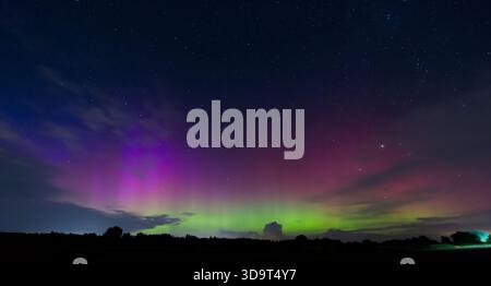 A stunning display of the aurora borealis from 18th September 2023 in South Denmark with vibrant colors of purple, green, and blue illuminating the ni Stock Photo