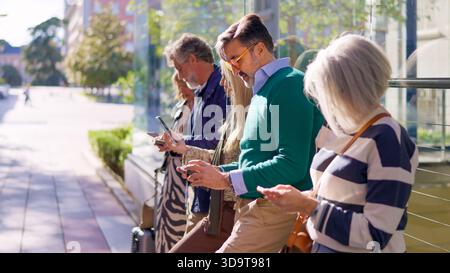 Seniors using their mobile phones outdoors Stock Photo