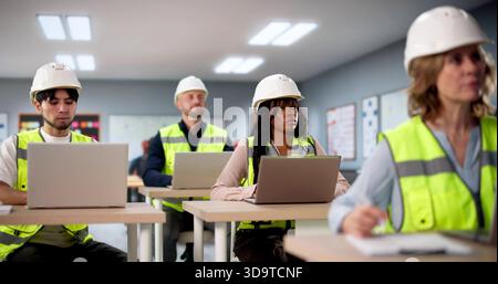 Young Students In University Classroom Working On Computers Together Happily Stock Photo