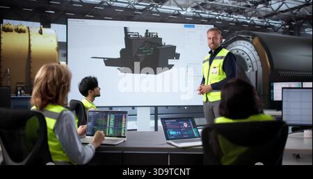 Engineer Leads Team At Gas Power Plant, Guiding Oil Processing. Workers Meet To Control Machine Heating Stock Photo