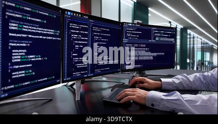 Mid-Age Caucasian Man Developing Cybersecurity Software Code On Computer Screen Stock Photo