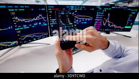 Smart Broker Analyzing Stock Market Trends On Mobile Phone Screen Stock Photo