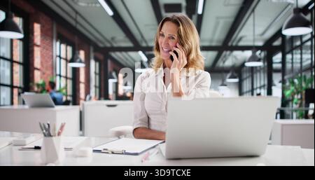 Smiling Executive Providing Training To Customer Service Representative On The Phone. Stock Photo