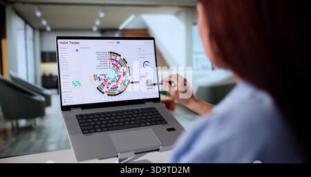 Professional Nutritionist Tracking Client Habits With Digital App On Laptop. Stock Photo
