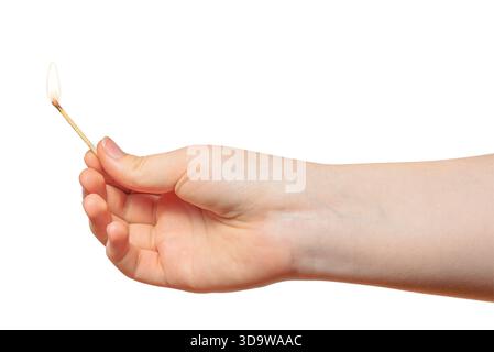 A child hand holding a thin burning match. Concept: children and fire. On a white background. Stock Photo