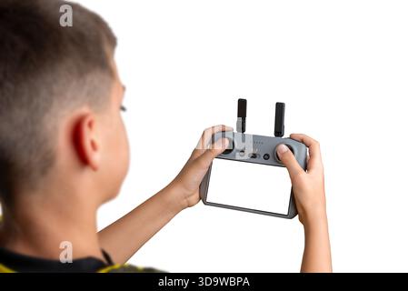 Boy holding a drone controller with blank screen, ideal for UI mockups, app design previews, or technology product presentations Stock Photo
