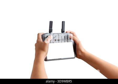 Hands holding an isolated drone controller with blank screen on white background, perfect for inserting custom UI or drone software previews Stock Photo