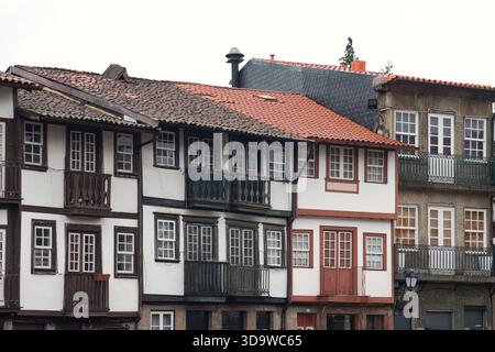 Largo da Oliveira in Guimaraes, Portugal, on a rainy cloudy day with wet stone streets and medieval architecture. Stock Photo