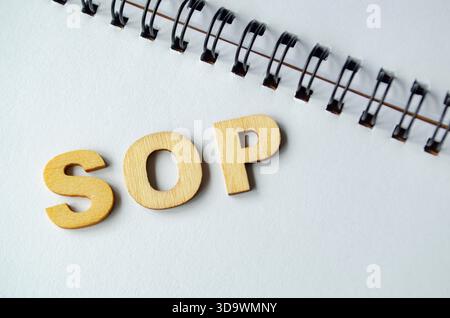 Standard Operating Procedures wooden text on white notepad Stock Photo