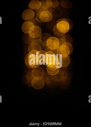 Warm golden bokeh lights glowing softly against dark background, abstract Christmas holiday ambiance, defocused fairy lights texture. Pro Photo. High Stock Photo