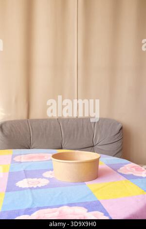 empty cardboard bowl on table with tablecloth Stock Photo