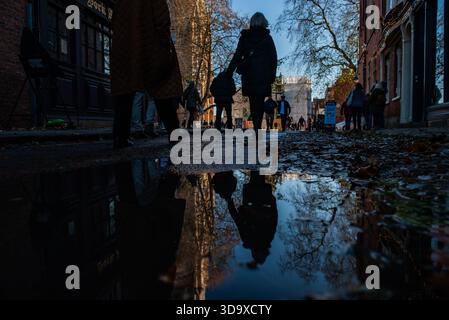 The streets of York are reflected in a puddle on a crisp Winter's day. Stock Photo