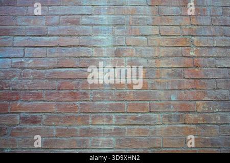 Wide red brick wall with uneven color and grunge texture Stock Photo