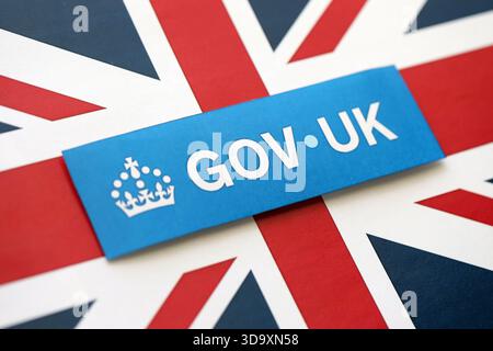 KYIV, UKRAINE - SEPTEMBER 17, 2025 Government GOV UK logotype sticker lies on UK flag close up Stock Photo