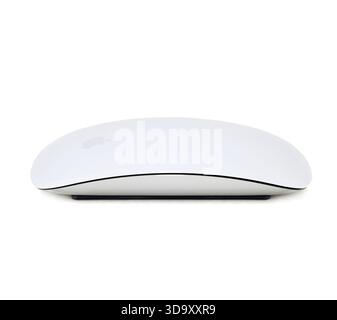 A white Apple mouse is sitting on a white background. The mouse is rectangular in shape and has a silver color Stock Photo