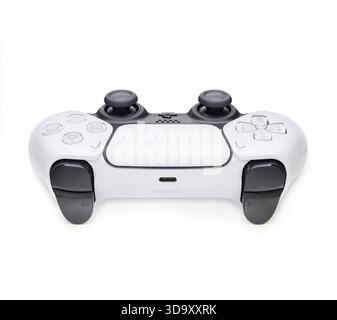 A white controller with black buttons and a black and white logo. The gamepad is the Nintendo Wii Stock Photo