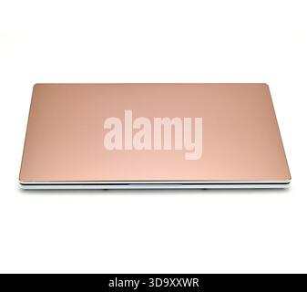 A laptop with a pink cover. The laptop is on a white background. The laptop is a silver color Stock Photo