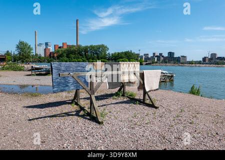 Midsummer's Eve in the city. Carpets hanging on rug drying rack in Sörnäinen district of Helsinki, Finland. Stock Photo