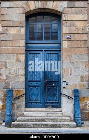 blue wooden decorative door, double entrance way, exterior architeture details Stock Photo