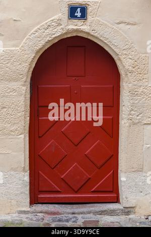 arched red wooden door, exterior architecture Stock Photo