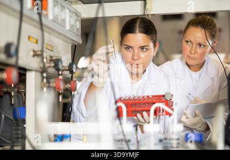 Confident women technicians working in research laboratory Stock Photo