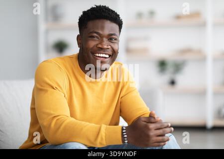 Portrait of successful black guy posing at home Stock Photo
