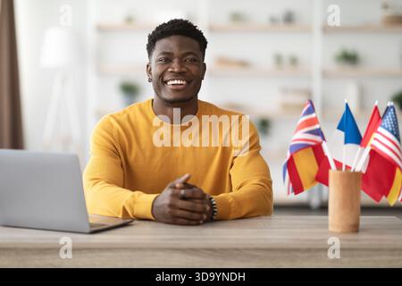 Happy black man teacher working at language school Stock Photo