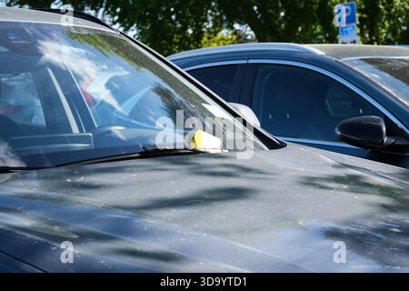 Nynashamn, Stockholm County, Sweden - May 29, 2025: A car with a yellow sticker on the windshield. The sticker is a parking ticket. The car is parked Stock Photo