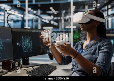 Data center admin using VR headset, analyzing software logs metrics, optimizing storage systems. Server farm IT expert inspecting resource utilization using virtual reality technology Stock Photo