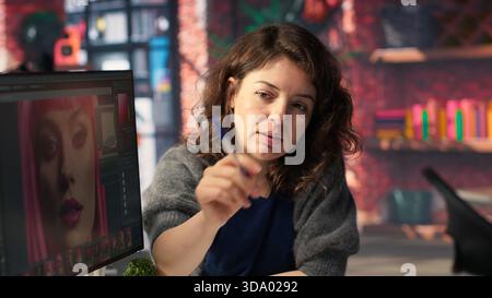 Photographers team collaborating on editing high quality content using a software. Editing interface provides advanced image enhancement and color correction tools, photo retouching. Camera B. Stock Photo